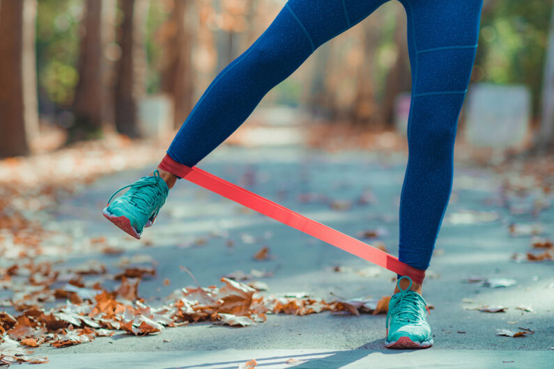 woman-exercising-with-resistance-band-outdoors